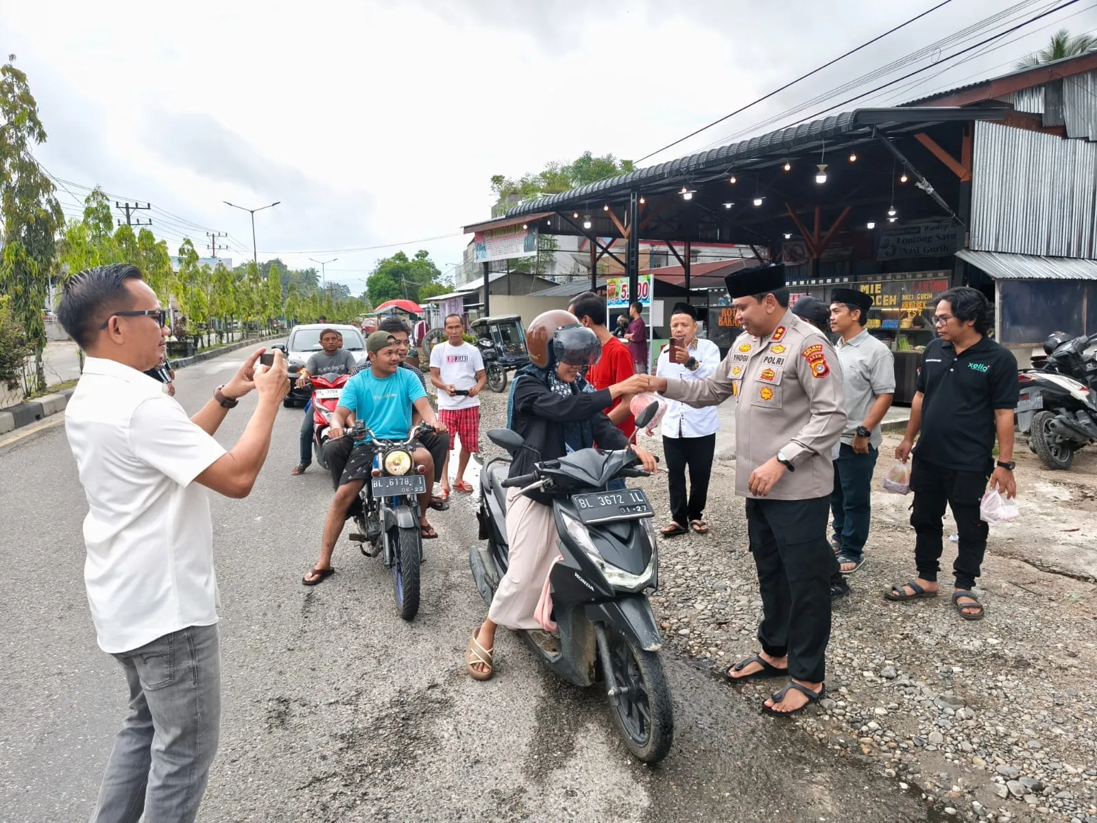 Foto: Kapolres Subulussalam AKBP Yhogi Hadisetiawan, bersama awak media/wartawan membagikan takjil kepada para pengguna jalan di Jln. Teuku Umar